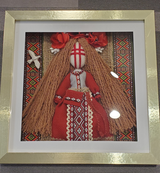 Motanka doll in frame