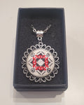 Metal pendant on a rope or chain which micro-embroidered name codes