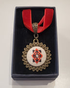 Metal pendant on a rope or chain which micro-embroidered name codes