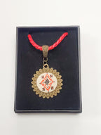 Metal pendant on a rope or chain which micro-embroidered name codes