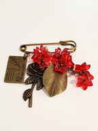 Brooch (glass, metal)
