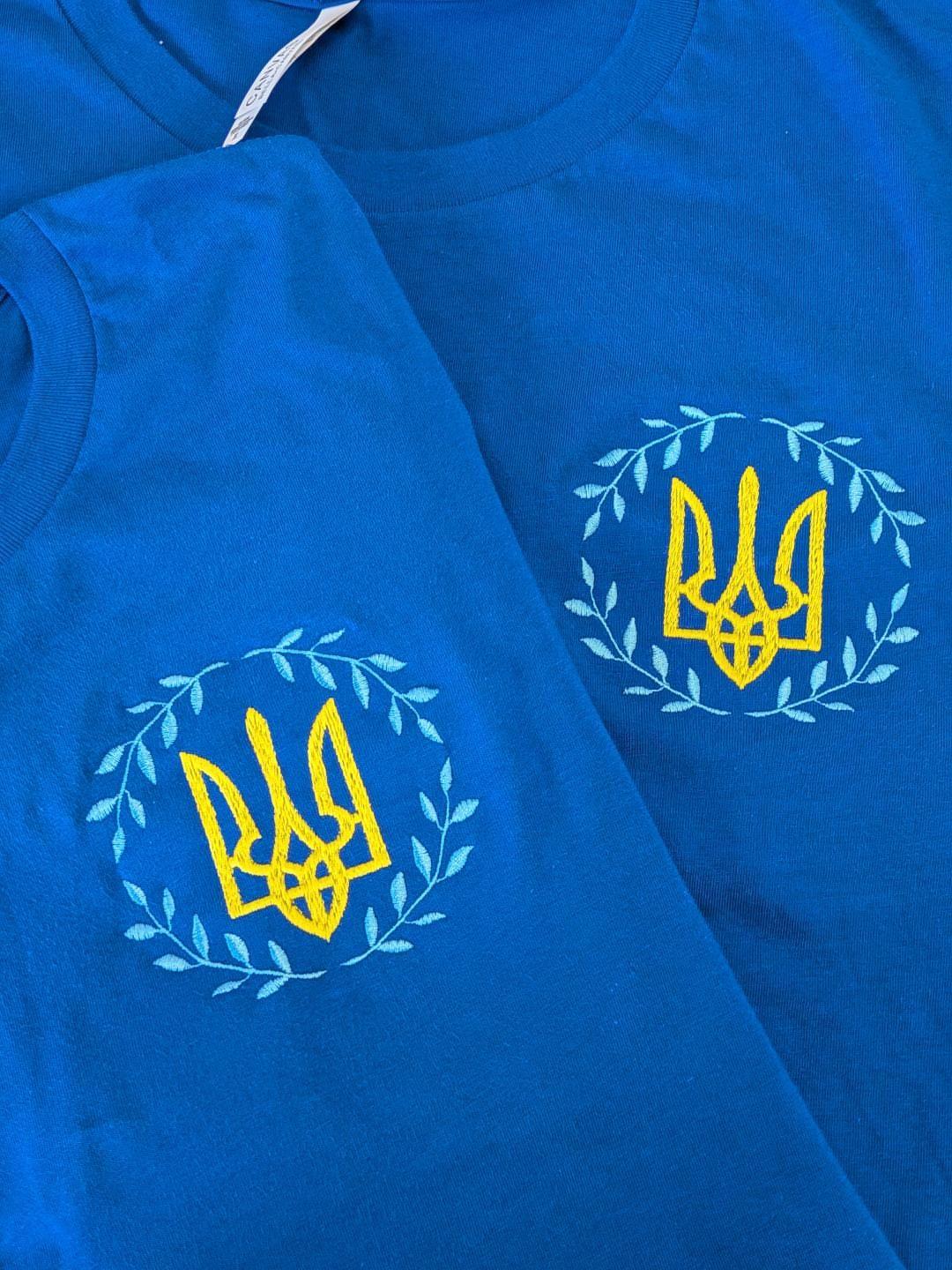 Royal blue T-shirt with an embroidered trident/wreath of leaves, Size L (women), XL (men) (Order)