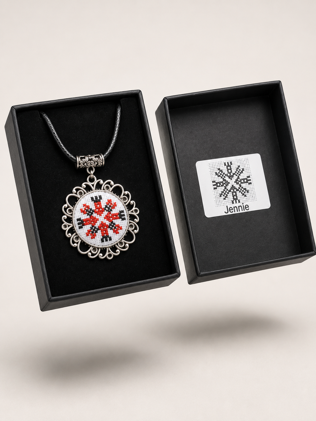 Metal pendant on a rope or chain which micro-embroidered name codes