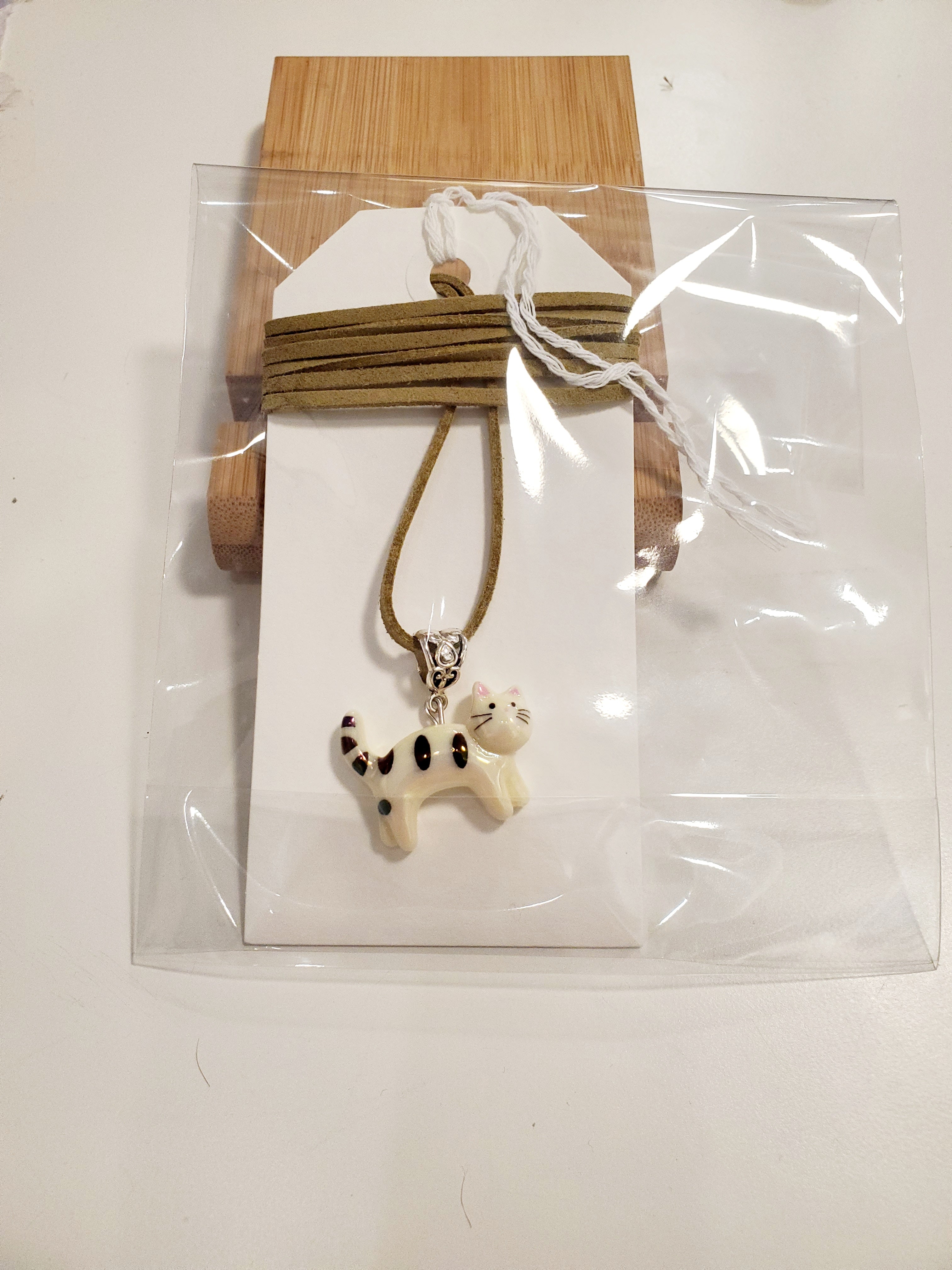 Cat pedant on a colored string