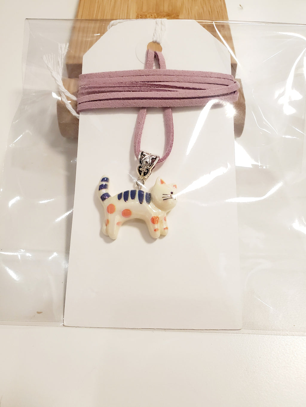 Cat pedant on a colored string