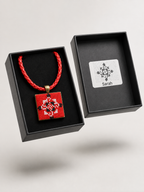 Metal pendant on a rope or chain which micro-embroidered name codes